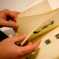 Jason Dean, cataloger and technical services librarian, shows the uncut pages in a rare copy of “The...