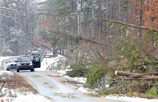 motorists-stop-to-view-power-lines-damaged-by-fallen-trees-after-the-winter-storm-that-hit-the-area-on-christmas-day-after-months-of-drought-during-the-summer-trees-became-brittle-and-limbs-broke-after-ice-and-heavy-snow-fell-according-to-tree-removal-experts