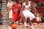 Arkansas guard Mardracus Wade knocks the ball away from Delaware State guard Chris Lewis (34) Saturday, Jan. 5, 2013, during the second half of play in Bud Walton Arena in Fayetteville.