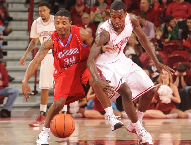 arkansas-guard-mardracus-wade-knocks-the-ball-away-from-delaware-state-guard-chris-lewis-34-saturday-jan-5-2013-during-the-second-half-of-play-in-bud-walton-arena-in-fayetteville