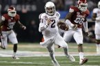 Texas A&M's Johnny Manziel (2) finds running room as Oklahoma's Javon Harris (30) and Chuka Ndulue (98) give chase in the first half of the Cotton Bowl NCAA college football game Friday, Jan. 4, 2013, in Arlington, Texas. (AP Photo/LM Otero)