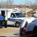 Central Emergency Medical Service employees work Friday to treat a motorist injured after the Ford M...