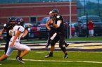 #4 QB Ty Storey looks down field as a Ozark defender pressures him.