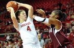 NWA Media/MICHAEL WOODS --01/06/2013-- Arkansas forward Sarah Watkins tries to get past Texas A&M defender Cierra Windham during Sunday afternoon's game at Bud Walton Arena in Fayetteville.