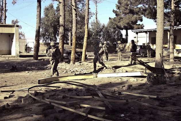 us-soldiers-with-the-nato-led-international-security-assistance-force-isaf-investigate-the-scene-after-suicide-attacks-in-spin-boldak-kandahar-province-south-of-kabul-afghanistan-sunday-jan-6-2013-two-suicide-bombers-penetrated-a-government-compound-in-the-countrys-south-sunday-killing-several-afghan-officials-said-there-were-no-reports-of-foreign-troops-or-civilians-at-the-site
