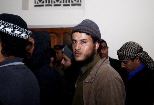 a-suspected-al-qaida-militant-attends-a-trial-session-along-with-other-militants-during-their-trial-at-a-state-security-court-in-sanaa-yemen-sunday-jan-6-2013-yemens-state-security-court-has-sentenced-five-alleged-al-qaida-militants-to-up-to-10-years-in-prison-for-carrying-out-attacks-against-security-forces-and-supporting-the-group-logistically-in-the-southern-province-of-abyan-in-2011