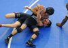 Jay Branch, top, of Fayetteville puts Tristan Engel of Branson, Mo., in a headlock Saturday while referee Roosevelt Hadley watches for the pin at Springdale Har-Ber. Branch pinned Engel to win.