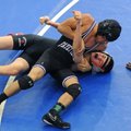 Jay Branch, top, of Fayetteville puts Tristan Engel of Branson, Mo., in a headlock Saturday while re...