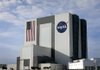 The NASA logo and U.S. flag mark the Vehicle Assembly Building at NASA Kennedy Space Center in Cape Canaveral, Fla. The 526-foot-tall structure is on NASA’s list to sell or lease. 