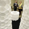 Stephen Coler, left, talks Friday about his sculptural arrangement made of foam cups with Gloria Sou...