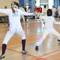 Elizabeth Kirk, left, competes in a fencing match at the Northwest Arkansas Fencing Center in Benton...