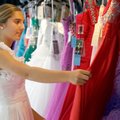 Jordan Maass, 15, looks over a selection of dresses Friday at White Dress Boutique in downtown Roger...