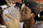 Alabama's AJ McCarron kissed The Coaches' Trophy after the BCS National Championship college football game against Notre Dame Monday, Jan. 7, 2013, in Miami. Alabama won 42-14. (AP Photo/David J. Phillip)