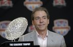 Alabama head coach Nick Saban poses with The Coaches' Trophy during a BCS National Championship college football game news conference Tuesday, Jan. 8, 2013, in Ft. Lauderdale, Fla. Alabama defeated Notre Dame 42-14 Monday night to win the national championship. (AP Photo/Morry Gash)