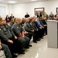 Members of the Benton County Sheriff’s Office listen as Tim Keck speaks. Keck is a former Rogers pol...