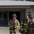 Firefighters leave a building after completing their smoke investigation Monday at 4 North Double Sp...