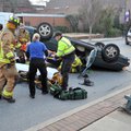 Fayetteville emergency responders attend to the driver of a Toyota Avalon Monday just after 5 p.m. a...