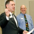 Lance Arbuckle, Rogers High School assistant principal, right, laughs while Richard Abernathy, execu...