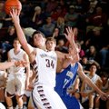 Siloam Springs junior Payton Henson stretches for a rebound against Harrison during the second half ...