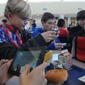 Jack Meyer, Adam Eisa and Mason Sell, from left, Kirksey MIddle School sixth-graders, use smart phon...