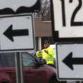 Chris Cash with the Rogers Street Department directs traffic Tuesday at Eighth and Walnut streets du...
