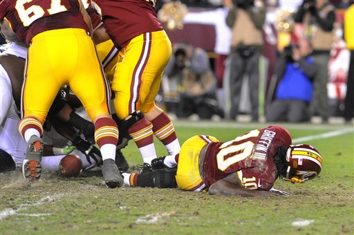 the-ball-is-loose-as-redskins-quarterback-robert-griffin-iii-lays-on-the-field-after-fumbling-the-snap-from-center-against-the-seahawks-during-the-fourth-quarter-of-their-nfl-playoff-football-game-sunday-jan-6-2012-in-landover-md-griffin-left-the-game-with-an-injured-right-leg-seattle-defeated-washington-24-14