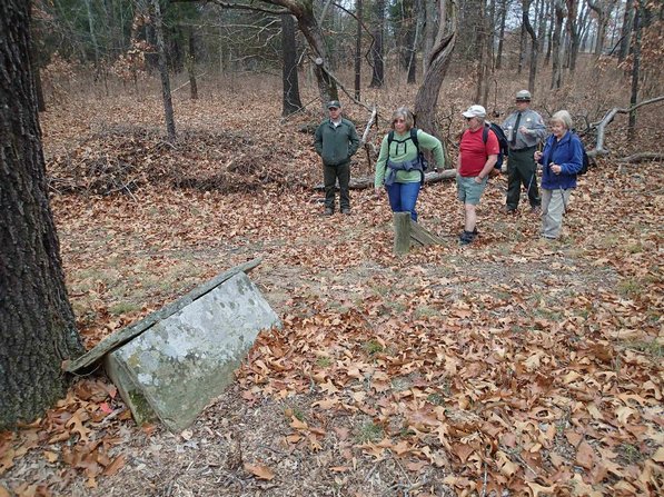 Curtis Tilghman, from left, Linda Heter, Dennis Heter, Patrick Poyner and Mary Chodrick explore a cemetery site during a hike at Pea Ridge National Military Park.