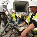 Daniel Kulberg, right, watches workers, including Ryan Albright, center, install liner to repair a s...
