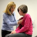Laura Jackson, physician assistant at the Wellness Center at Jones Elementary School, takes a few vi...