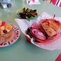 The Red Hen Bakery & Cafe’s most popular item is the Red Hen Burger, which is shown here with fruit ...