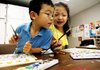 Torrie Pianalto, left, and Sophia Flores, both of Springdale, share a paint palette at the Arts Center of the Ozarks in Springdale. Art classes start in January. 