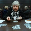 Barbara Davis deals cards Thursday while playing party bridge at the Benton County Senior Activity a...