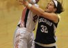 Little Rock Hall’s Tiarra Coffey (40) blocks a shot by Greenwood’s Megan Hartness (32) during Friday’s game in Little Rock. Coffey ÿnished with 15 points and nine rebounds for the Lady Warriors as they won 52-45. 