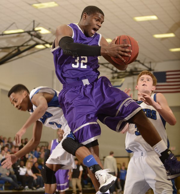 Fayetteville’s Manuale Watkins, center, grabs ...