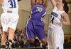 Fayetteville’s Catara Robinson, center, makes a jump shot between Rogers’ McKinzie James, left, and Samantha Warren during Friday’s game at King Arena in Rogers. 