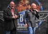Ken Mourton, left, chairman of the Bikes Blues & BBQ rally, and Joe Giles, its executive director, address the audience Friday evening at the Fayetteville Town Center during an event celebrating the organizations charitable contributions to 28 local charities.