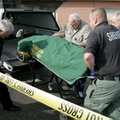 Greenland Police Chief Gary G. Ricker, left, helps Washington County personnel load the body of Bett...