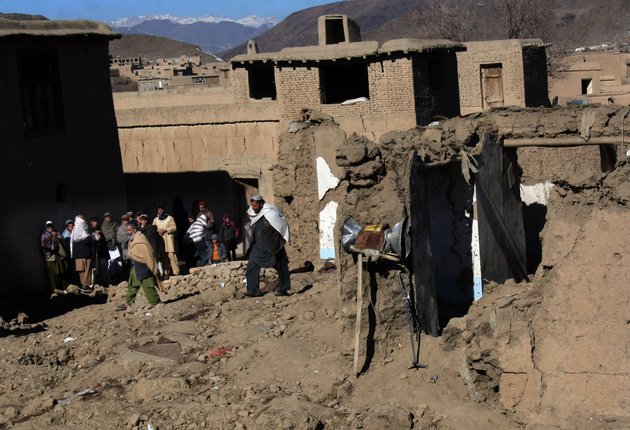afghans-stand-near-a-damaged-mosque-following-an-explosion-in-sayedabad-wardak-southwest-of-kabul-afghanistan-sunday-jan-13-2013-an-explosion-killed-seven-afghan-villagers-sunday-as-they-tried-to-pull-bodies-of-insurgents-killed-from-the-rubble-of-a-village-mosque-after-a-night-raid-by-nato-and-afghan-troops-in-the-countrys-east-officials-said-four-insurgents-and-an-afghan-soldier-were-also-reported-to-have-been-killed