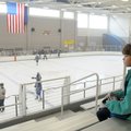 Brianne Ginn, 9, of Little Rock, watches the end of the hockey game Sunday between the Northwest Ark...