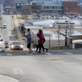 Pedestrians cross Dickson Street Friday near the University of Arkansas in Fayetteville. The city of...