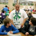 James Sandoval, Elmwood Middle School volunteer, talks Thursday with seventh-graders Eli Crawford an...