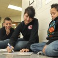 Magnolia Bahena, 16, Springdale High School junior, works on a spelling list Friday with George Elem...