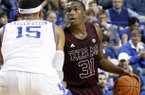Texas A&M's Elston Turner, right, looks for an opening against Kentucky's Willie Cauley-Stein during the first half of an NCAA college basketball game at Rupp Arena in Lexington, Ky., Saturday, Jan. 12, 2013. (AP Photo/James Crisp)