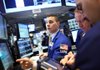 Traders work Monday on the floor of the New York Stock Exchange. A drop in Apple Inc. shares held down the Standard & Poor’s 500 index on Monday. 