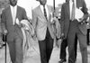 The Rev. Ralph Abernathy (from left), Rev. Dr. Martin Luther King, Jr., and Bayard Rustin, leaders of the bus boycott in Montgomery, Ala., in 1956, leave the Montgomery County Courthouse after appearing in court. 