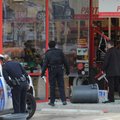Rogers police officers, left, and an employee at Advance Auto Parts on Eighth Street in Rogers look ...
