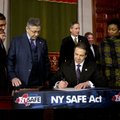 New York Gov. Andrew Cuomo signs a bill toughening gun laws in his state as leading lawmakers gather...