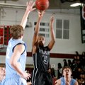 Tereke Eckwood, a Springdale sophomore, puts up a shot over the defense of Springdale Har-Ber senior...