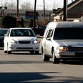 A funeral procession moves east Wednesday along West Meadow Avenue from Sisco Funeral Chapel in Spri...