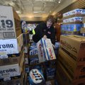 Barb Trusty, general manager for Kum & Go store No. 408, sorts through cases of beer Wednesday, Jan....
